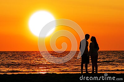 Couple walking under the sunset