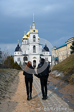 A couple walks to Assumption cathedral. Editorial Stock Photo
