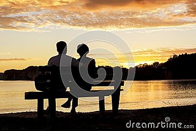 Couple watching a beautiful sunset together Stock Photo