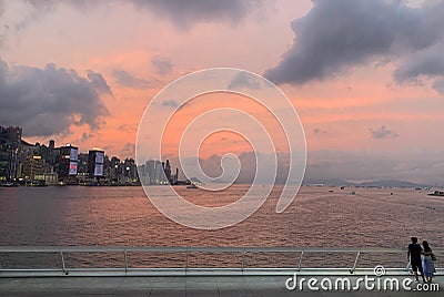 Couple watching evening glow in Victoria harbour in hong kong Editorial Stock Photo