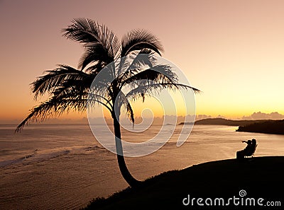 Couple watching sunrise in Kauai Stock Photo