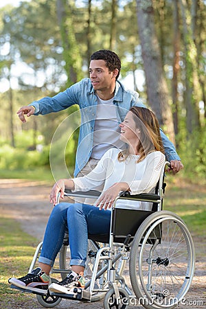 couple with wheelchair in autumn forest Stock Photo