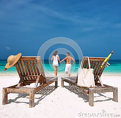 Couple in white running on a beach at Maldives Stock Photo