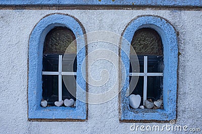 Windows with heart stones, Kinira, Greece Stock Photo