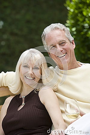 Couple With Wineglass In Garden Stock Photo