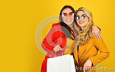 Couple of women go shopping. two female carry shopping bags. big sales and black friday. bright autumn colors. autumn Stock Photo