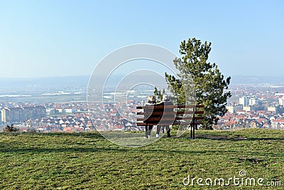 Couple on wooden bench and panoramic view of the town of Leskovac Stock Photo