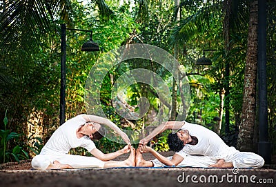 Couple yoga in the garden Stock Photo