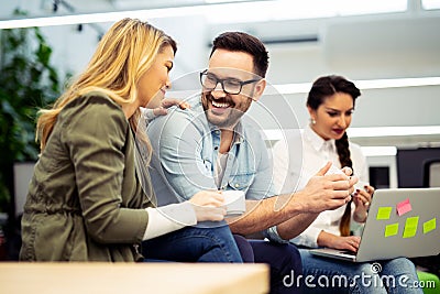 Couple of young coworkers looking at each other Stock Photo