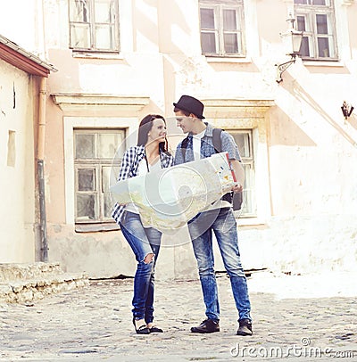 Couple of young travelers with a map Stock Photo