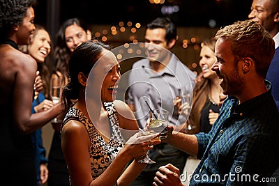 Couples Dancing And Drinking At Evening Party Stock Photo
