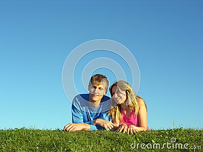 Couples lie on grass Stock Photo