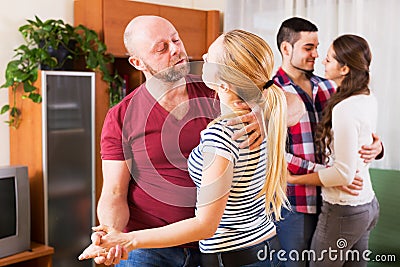 Couples smiling and moving in slow dance Stock Photo