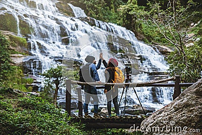 Couples traveling to relax, see nature, waterfall mae ya during the holidays at chiangmai in thailand Stock Photo