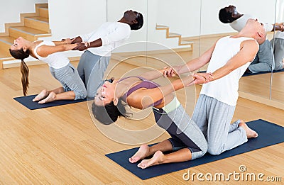 Couples yoga classes in modern fitness center Stock Photo