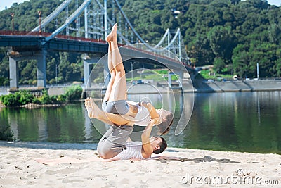 Earnest man and woman posing during couples yoga Stock Photo