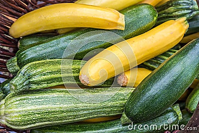 Courgettes zucchini marrow in a basked freshly picked on a farmers market day. Vivid green and yellow colors concept Stock Photo