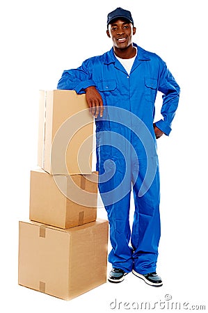 Courier boy standing beside boxes Stock Photo