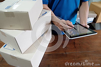 Courier checking the delivery receipt in office. Stock Photo