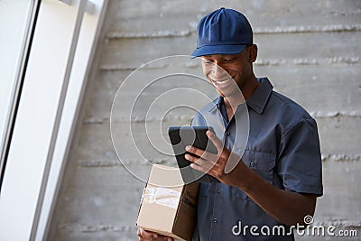 Courier Collecting Package From Office Stock Photo