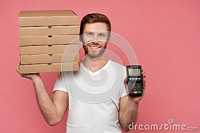 Courier holds many pizza boxes isolated on wall Stock Photo