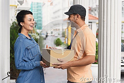 Courier making delivery to beautiful woman Stock Photo