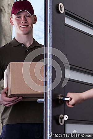 The courier provides a parcel home Stock Photo