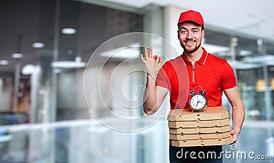 Courier is punctual to deliver quickly pizzas at home Stock Photo