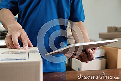 Courier checking the delivery receipt in office. Stock Photo