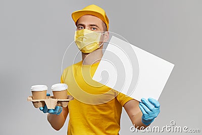 Courier in yellow uniform, protective mask and gloves delivers takeaway food and coffee. Delivery service under quarantine. Stock Photo