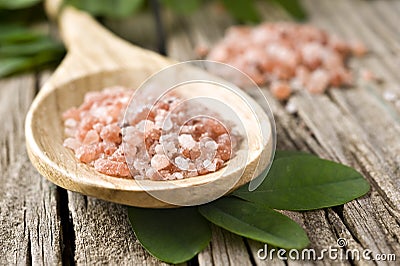 Course pink Himalayan salt on a wooden spoon Stock Photo