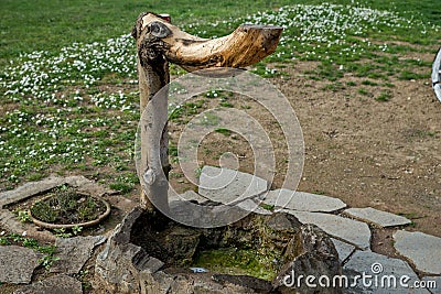 Courtyard fountain in a decorative casing made of wood Stock Photo