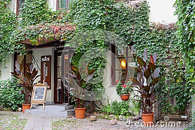 Courtyard of an idyllic cafe restaurant, Vilnius, Lithuania Editorial Stock Photo