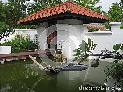 The courtyard with the pond, white wall and gate Stock Photo