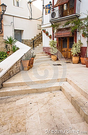 Courtyard in Santa Cruz old historic district of Alicante, terracota flowerpots, old houses Editorial Stock Photo