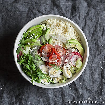 Couscous and fresh vegetables buddha bowl. Healthy, diet, food concept. Cous cous, quail eggs, tomatoes, radish, arugula, avocado Stock Photo
