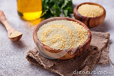 Couscous grain in wooden bowl Stock Photo