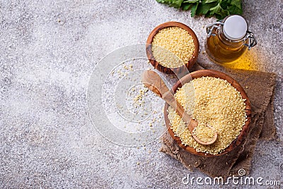 Couscous grain in wooden bowl Stock Photo