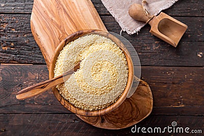 Couscous grain in wooden bowl. Top view Stock Photo