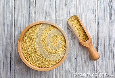 Couscous in wooden bowl Stock Photo