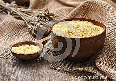 Couscous in a wooden bowl Stock Photo