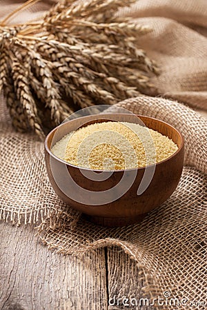 Couscous in a wooden bowl Stock Photo