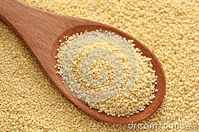 Couscous in a wooden spoon Stock Photo