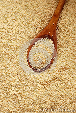 Couscous and wooden spoon Stock Photo