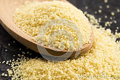 Couscous in wooden spoon Stock Photo