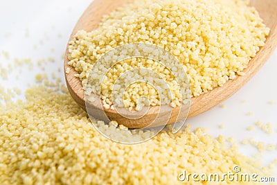 Couscous in wooden spoon Stock Photo