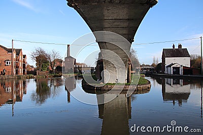 Coventry canal waters oxford canal route reflections of bridge and buildings hawkesbury junction Stock Photo