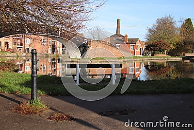 Coventry canal waters oxford canal route reflections of bridge and buildings hawkesbury junction Stock Photo