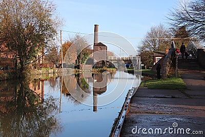 Coventry canal waters oxford canal route reflections of bridge and buildings hawkesbury junction Stock Photo