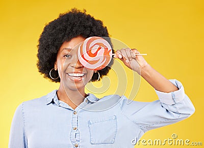 Cover, candy and lollipop with black woman in studio for colorful, cheerful and positive. Young, happiness and dessert Stock Photo